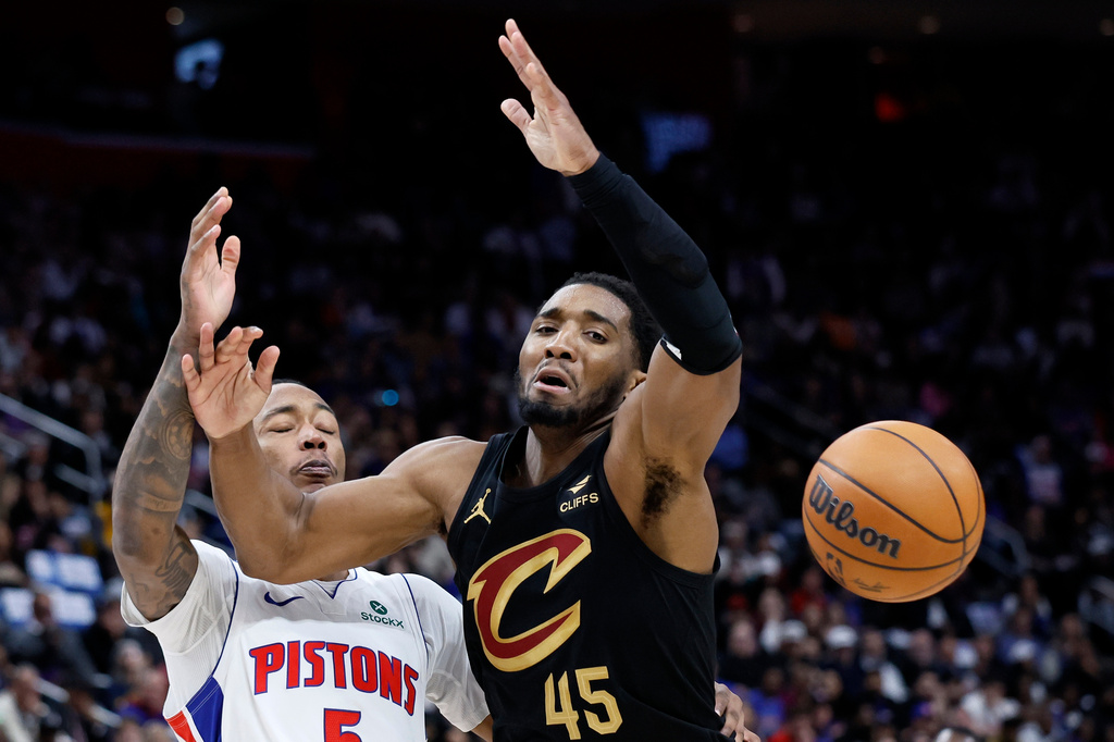 Cleveland Cavaliers guard Donovan Mitchell (45) looses the ball against the defense from Detroit Pistons forward Ronald Holland II during the first half in Game 2 of a second-round NBA playoffs basketball series, Thursday, May 7, 2026, in Detroit. (AP Photo/Duane Burleson)