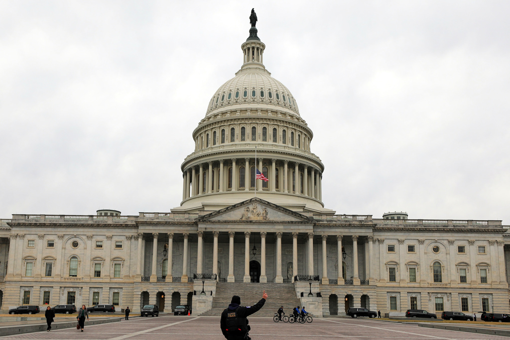 A U.S. Capitol Police officer patrols on the East Front of the U.S. Capitol, Wednesday, Jan. 14, 2026, in Washington. (AP Photo/Rahmat Gul)