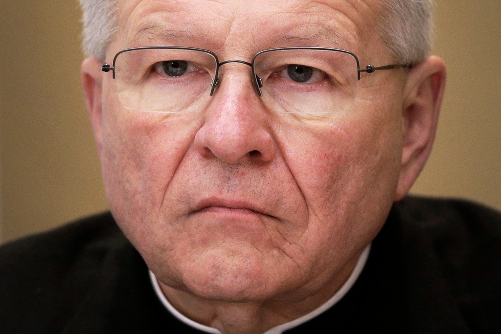 FILE - Archbishop Gregory Aymond, of New Orleans, listens during a news conference at the United States Conference of Catholic Bishops' annual fall meeting in Baltimore, Nov. 12, 2013. (AP Photo/Patrick Semansky, File)