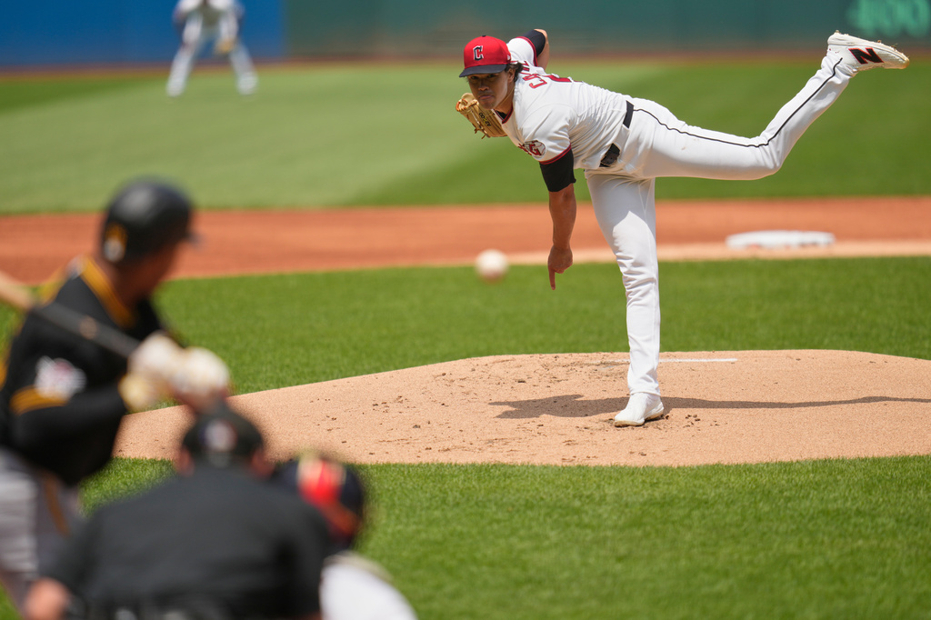 Cleveland Guardians' Joey Cantillo, right, pitches to Pittsburgh Pirates' Esmerlyn Valdez, left, in the first inning of a baseball game in Cleveland, Sunday, July 19, 2026. (AP Photo/Sue Ogrocki)