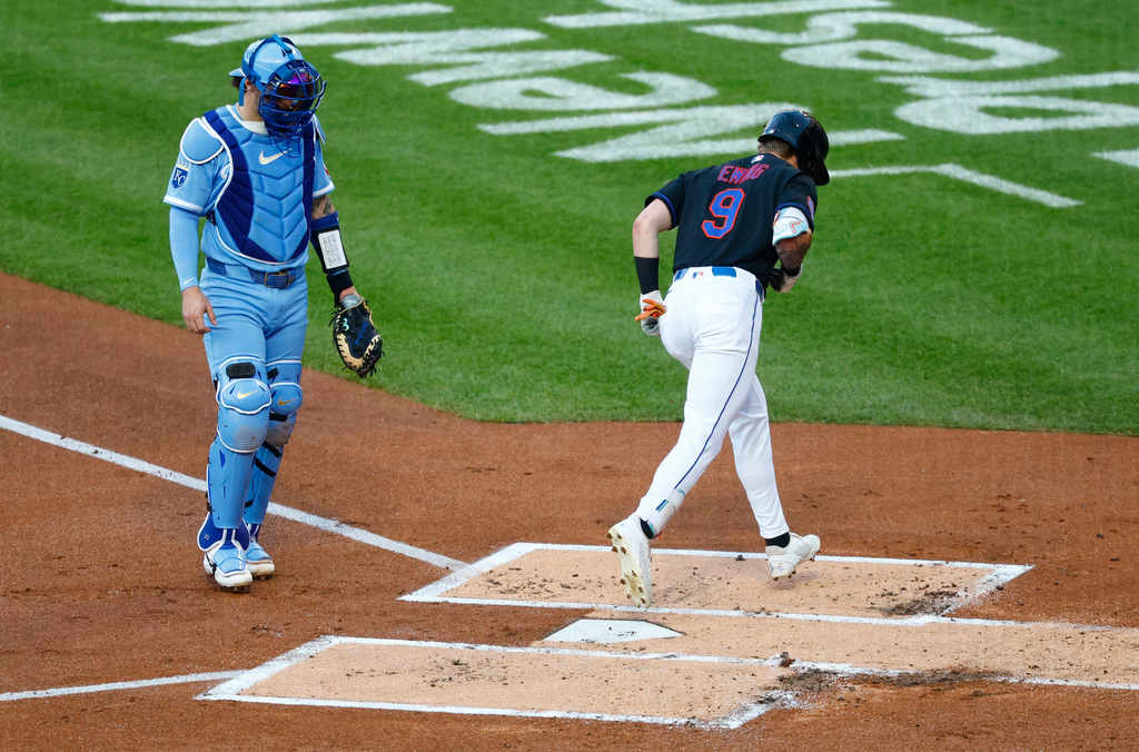 Kansas City Royals catcher Carter Jensen, left, watches as New York Mets' A.J. Ewing (9) crosses home plate to score after hitting a home run during the first inning of a baseball game, Wednesday, July 8, 2026, in New York. (AP Photo/Noah K. Murray)