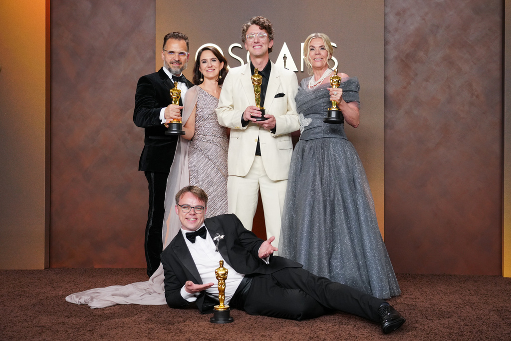 Pavel Talankin, front center, and Radovan Sibrt, top left, Alzbeta Karaskova, David Borenstein, and Helle Faber, winners of the award for documentary feature film for "Mr. Nobody against Putin," pose in the press room at the Oscars on Sunday, March 15, 2026, at the Dolby Theatre in Los Angeles. (Photo by Jordan Strauss/Invision/AP)