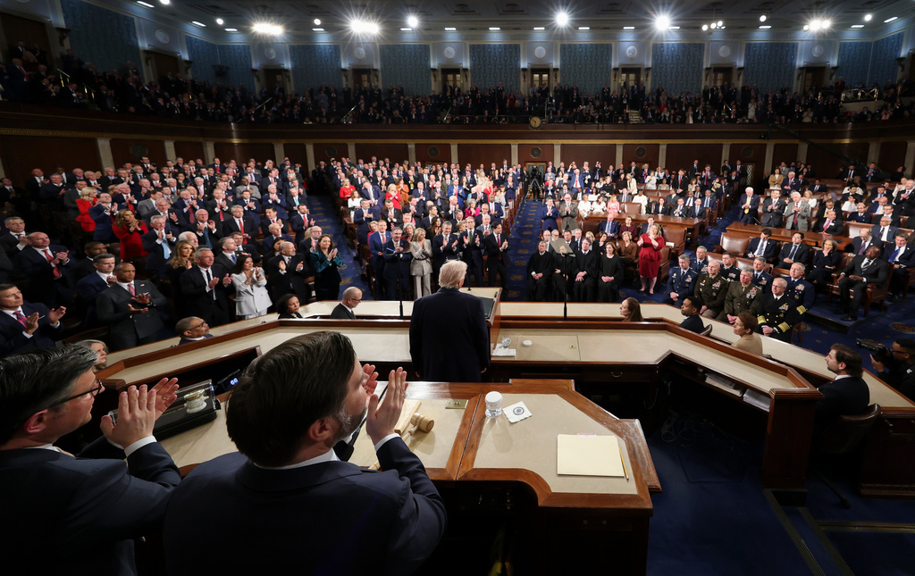 Members of the Congress give a standing ovation as President Donald Trump delivers the State of the Union address to a joint session of Congress in the House chamber at the U.S. Capitol in Washington, Tuesday, Feb. 24, 2026. (Jessica Koscielniak/Pool Photo via AP)