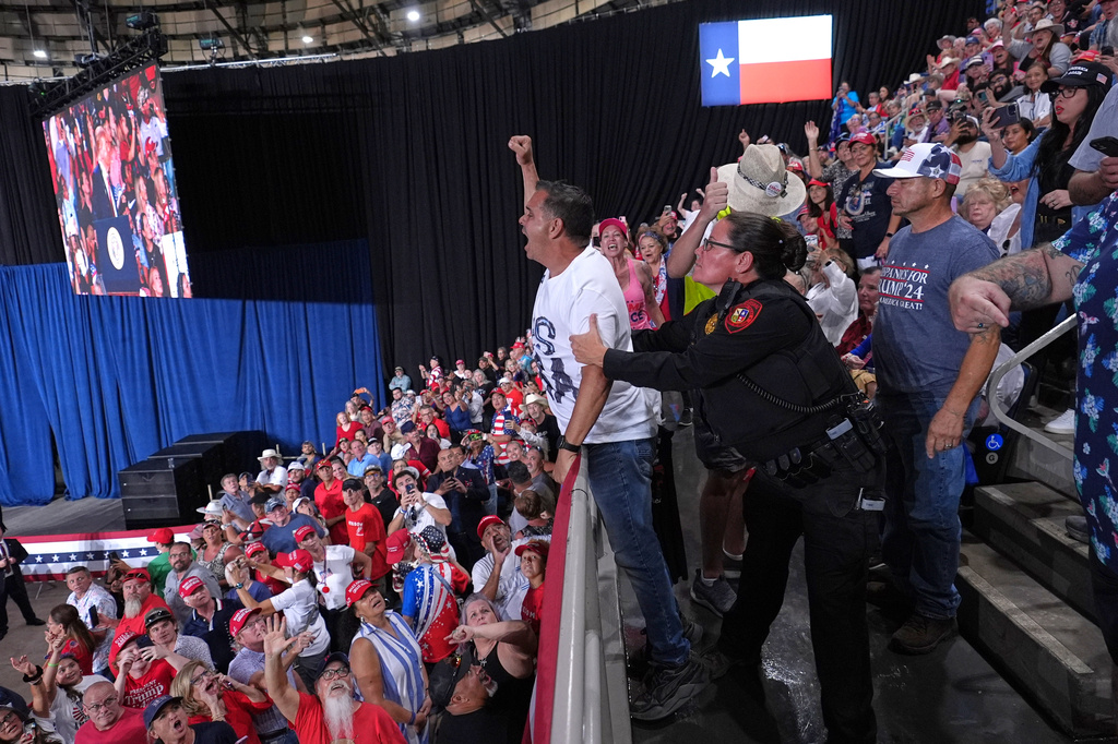Police remove a protester as President Donald Trump speaks at a campaign rally at the Freeman Coliseum in San Antonio, Wednesday, Oct. 7, 2026. (AP Photo/Alex Brandon)