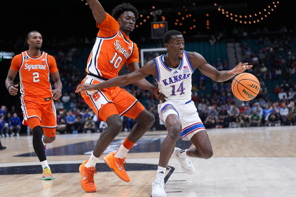 Kansas guard Melvin Council Jr. (14) tries to work the ball around Syracuse forward Ibrahim Souare (10) during the first half of an NCAA college basketball game in the Players Era tournament Las Vegas, Tuesday, Nov. 25, 2025. (AP Photo/Eric Gay)