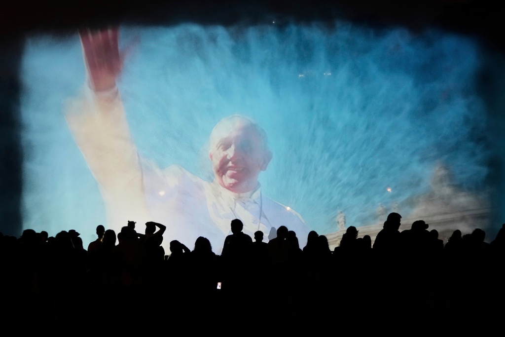 A portrait of the late Pope Francis is projected onto a water fountain at Magic Water Circuit, in Lima, Peru, April 21, 2025. (AP Photo/Martin Mejia, File)