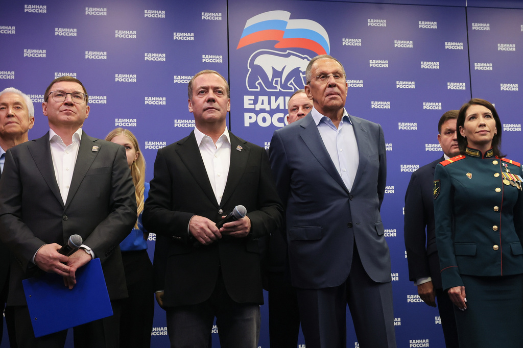 Russian Security Council Deputy Chairman and the head of the United Russia party Dmitry Medvedev, center, and Russian Foreign Minister Sergey Lavrov, center right, stand with other party members as they watch preliminary voting results for Russian parliamentary elections at the United Russia's headquarters in Moscow, Russia, Sunday, Sept. 20, 2026. (Ekaterina Shtukina, Sputnik, Kremlin Pool Photo via AP)