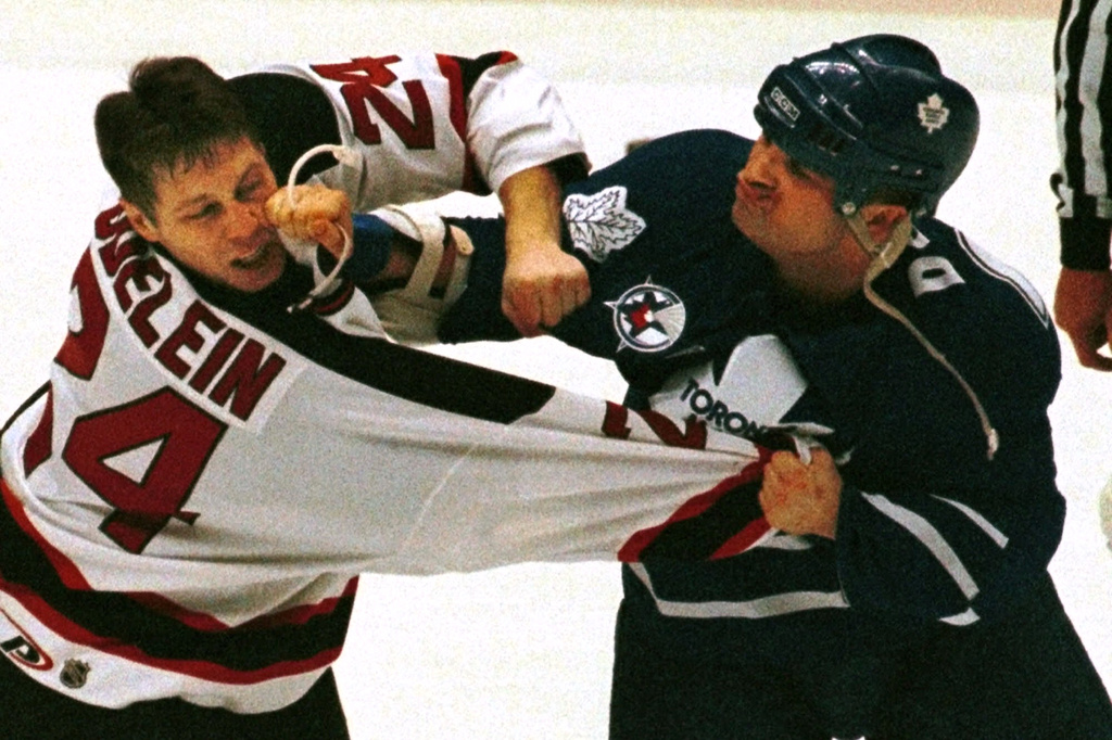 FILE - Toronto Maple Leafs' Tie Domi, right, and New Jersey Devils' Lyle Odelein fight during the first period of an NHL game, Feb. 25, 2000, in East Rutherford, N.J. (AP Photo/Bill Kostroun, File)