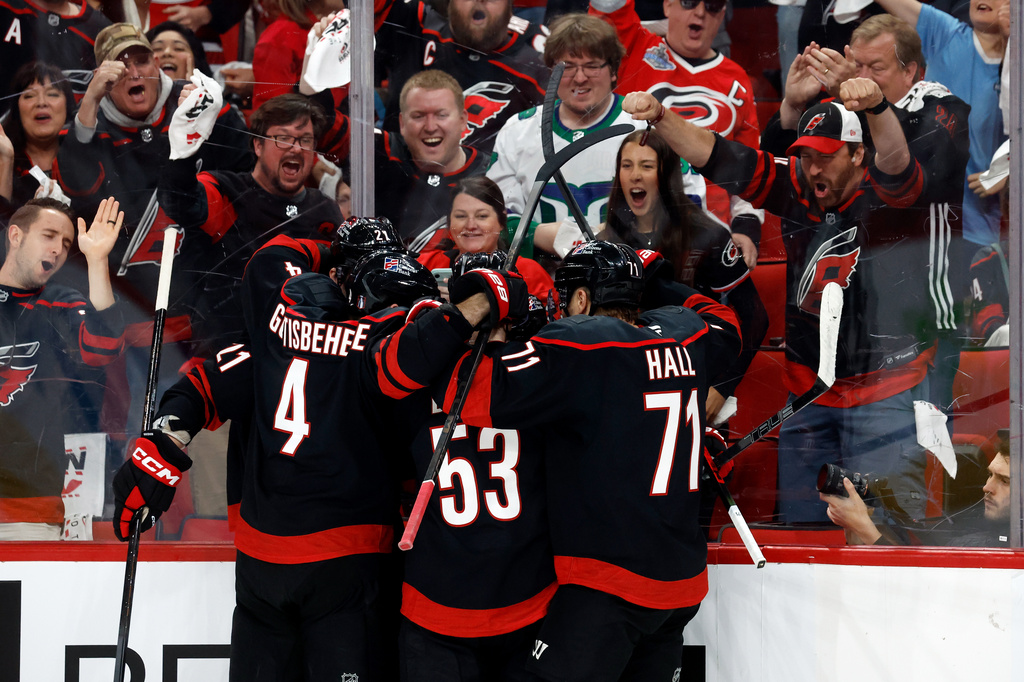 Carolina Hurricanes celebrate a goal by Logan Stankoven (22) during the second period of an Game 1 of an NHL hockey Stanley Cup first-round playoff series against the Ottawa Senators in Raleigh, N.C., Saturday, April 18, 2026. (AP Photo/Karl DeBlaker)