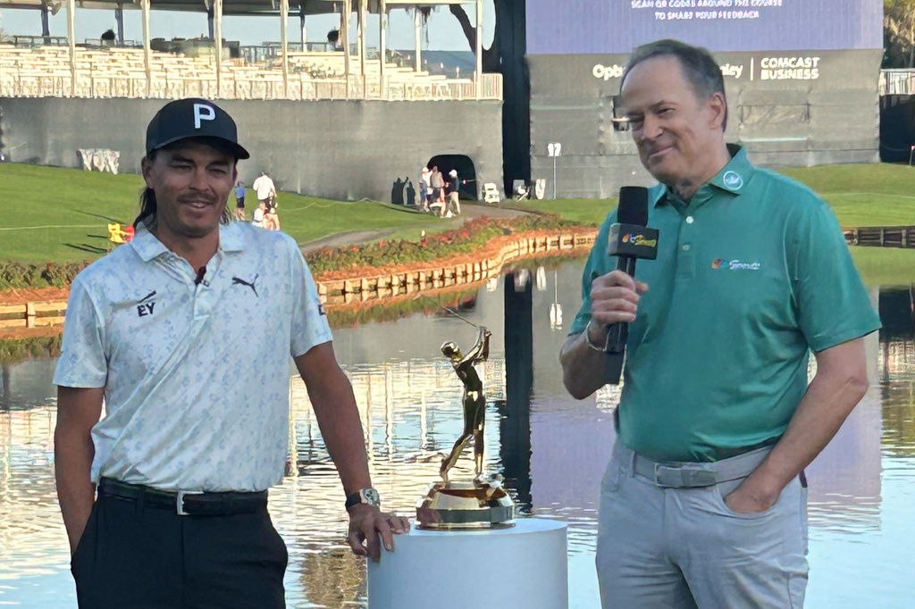 This photo provided by NBC Sports shows NBC Sports announcer Dan Hicks, right, interviewing Rickie Fowler during The Players Championship golf tournament at TPC Sawgrass in Ponte Vedra Beach, Fla., March 2026. (Dan Masonson/NBC Sports via AP)