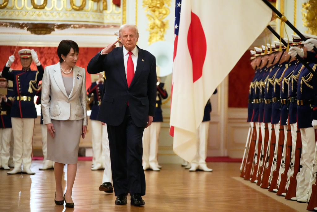 President Donald Trump, center, reviews an honour guard, escorted by Japan's Prime Minister Sanae Takaichi on his arrival at Akasaka Palace in Tokyo, Japan, Tuesday, Oct. 28, 2025. (AP Photo/Mark Schiefelbein)