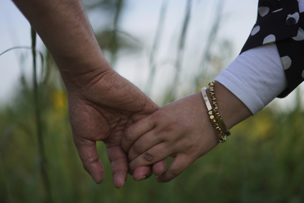 Faroz Waziri and his wife Mena, both refugees from Afghanistan who settled in Cedar Rapids, Iowa, roughly 10 years ago, hold hands on Friday, Aug. 8, 2025, in Cedar Rapids. (AP Photo/Jessie Wardarski)