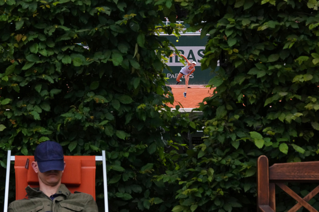 A spectator takes a nap next to a court of the French Tennis Open, at the Roland-Garros stadium, in Paris, May 29, 2025. (AP Photo/Lindsey Wasson, File)