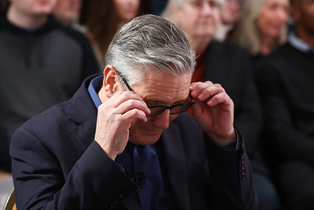 Britain's Prime Minister Keir Starmer adjusts his glasses as he waits to deliver his speech at Horntye Park Sports Complex in St Leonards-on-Sea, East Sussex, England, Thursday, Feb. 5, 2026. (Peter Nicholls/Pool Photo via AP)