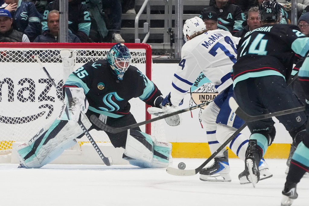 Seattle Kraken goaltender Joey Daccord (35) blocks a shot from Toronto Maple Leafs center Bobby McMann (74) during the third period of an NHL hockey game Thursday, Jan. 29, 2026, in Seattle. (AP Photo/Lindsey Wasson)