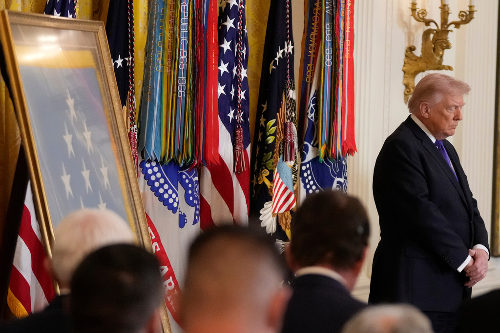 President Donald Trump stands during a prayer before a Medal of Honor ceremony in the East Room of the White House, Monday, March 2, 2026, in Washington. (AP Photo/Mark Schiefelbein)