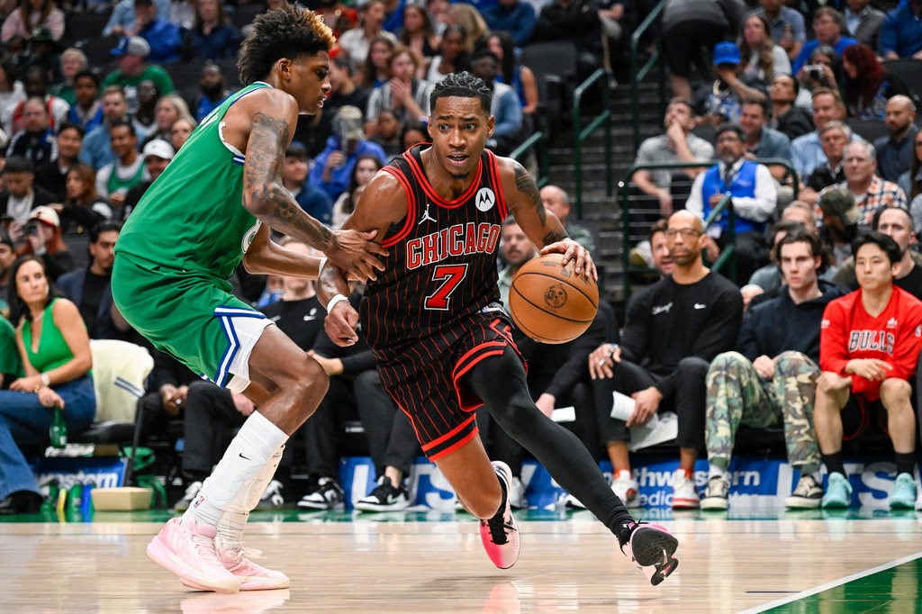 Chicago Bulls' Rob Dillingham drives against Dallas Mavericks' AJ Johnson during an NBA basketball game Sunday, April 12, 2026, in Dallas. (AP Photo/Albert Pena)