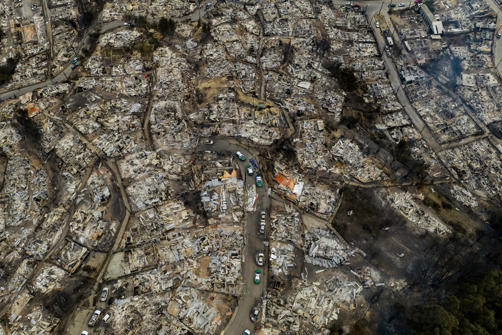 Areas lie burned by wildfires near Lirquen, Chile, Sunday, Jan. 18, 2026. (AP Photo/Javier Torres)
