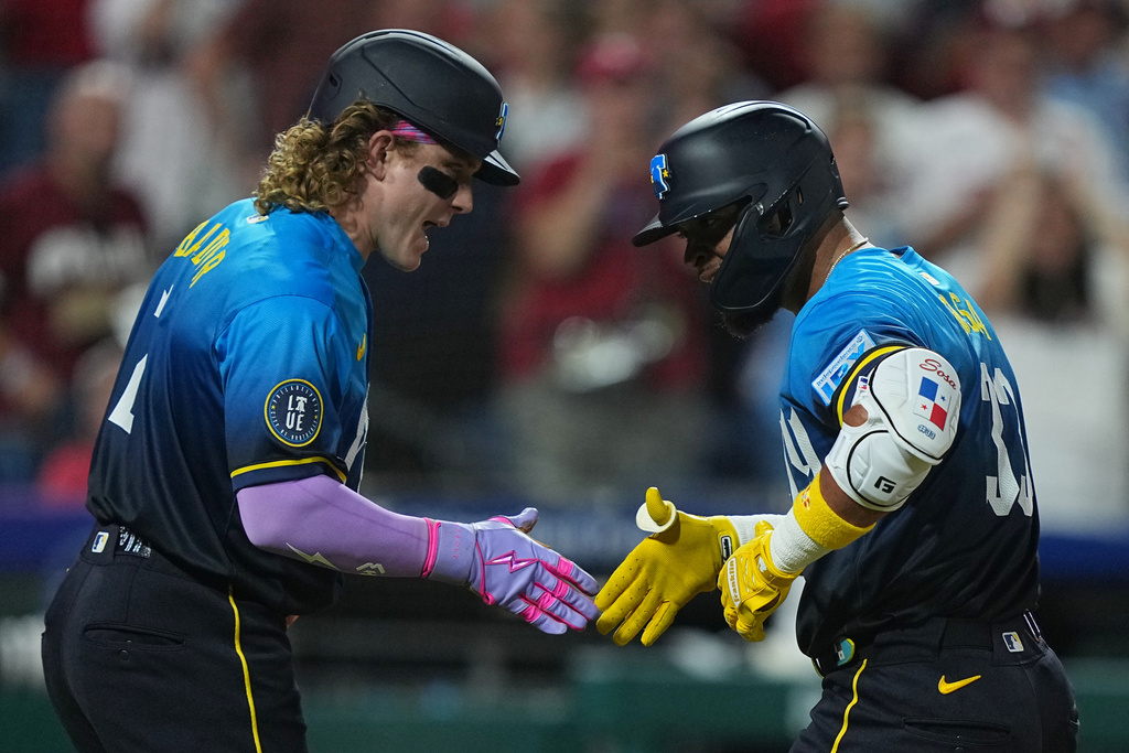 Philadelphia Phillies' Edmundo Sosa, right, celebrates his home run off of Minnesota Twins pitcher Joe Ryan with teammate Harrison Bader during the fifth inning of a baseball game, Friday, Sept. 26, 2025, in Philadelphia. (AP Photo/Matt Rourke)