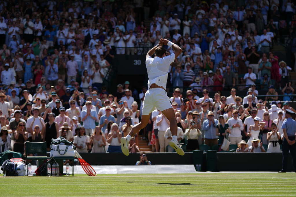 Flavio Cobolli of Italy celebrates winning against Alex de Minaur of Australia in their fourth round men's singles match at the Wimbledon Tennis Championships in London, Monday, July 6, 2026. (AP Photo/Maja Smiejkowska)