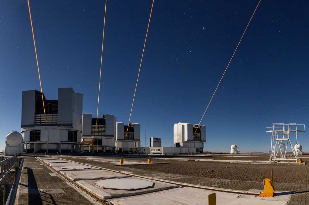 This photo made with a long exposure and released by the European Southern Observatory (ESO) on Nov. 10, 2025, shows four lasers at ESO's Paranal Observatory, each one launched from one of the four eight-meter telescopes on site in Taltal, Chile. (A. Berdeu/European Southern Observatory via AP)