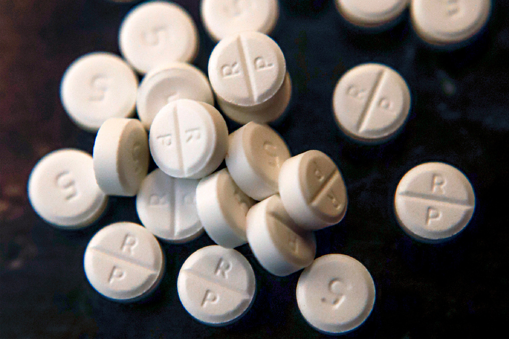 FILE - Several 5-mg pills of Oxycodone are seen June 17, 2019, in Zelienople, Pa. (AP Photo/Keith Srakocic, File)