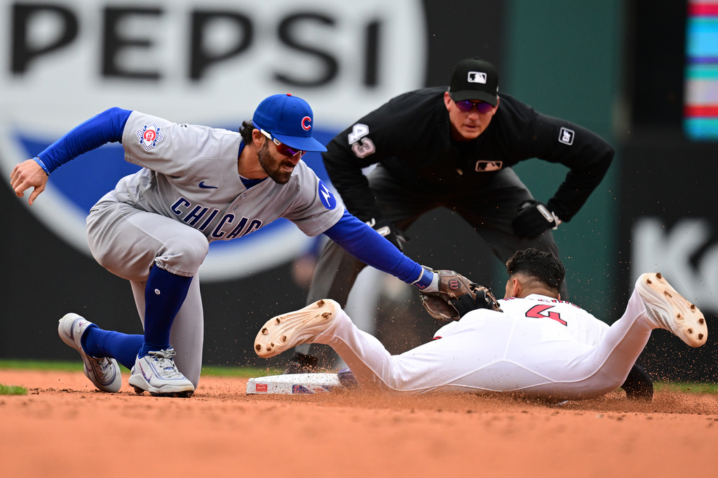 Cleveland Guardians' Brayan Rocchio is tagged out attempting to steal second base by Chicago Cubs shortstop Dansby Swanson during the third inning of a baseball game, Sunday, April 5, 2026, in Cleveland. (AP Photo/David Dermer)