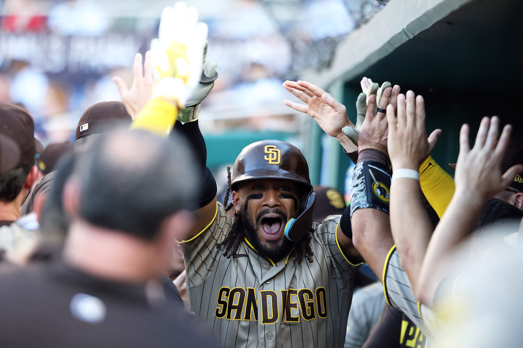 San Diego Padres' Fernando Tatis Jr. celebrates with his teammates after hitting a home run during the fifth inning of a baseball game against the Washington Nationals, Saturday, May 30, 2026, in Washington. (AP Photo/Daniel Kucin Jr.)
