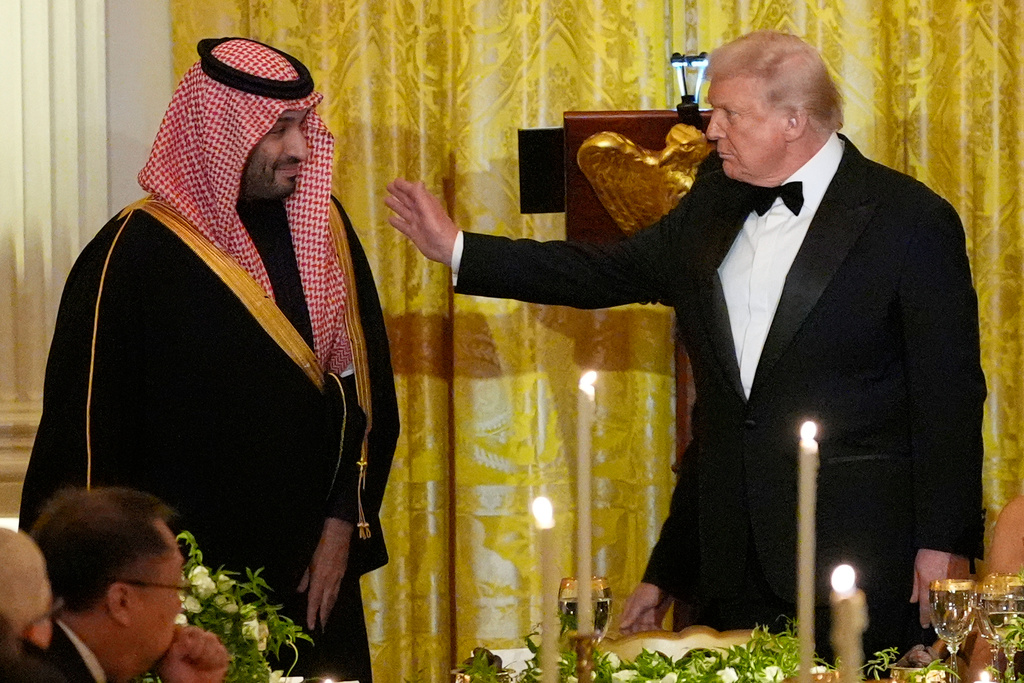 President Donald Trump and Saudi Arabia's Crown Prince Mohammed bin Salman prepare to take their seats during a dinner in the East Room of the White House, Tuesday, Nov. 18, 2025, in Washington. (AP Photo/Alex Brandon)