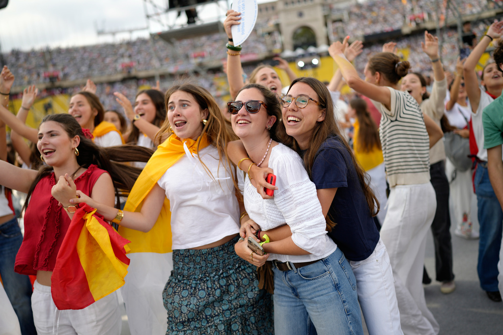 Young people dance to the music before the arrival of Pope Leo XIV to attend a prayer vigil at Lluis Companys Olympic Stadium in Barcelona, Spain, Tuesday, June 9, 2026. (AP Photo/Bernat Armangue)