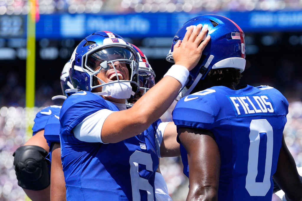 New York Giants' Jaxson Dart (6) celebrates with wide receiver Malachi Fields (0) after connecting for a touch pass against the Minnesota Vikings during the first half of a preseason NFL football game Saturday, Aug. 15, 2026, in East Rutherford, N.J. (AP Photo/Yuki Iwamura)