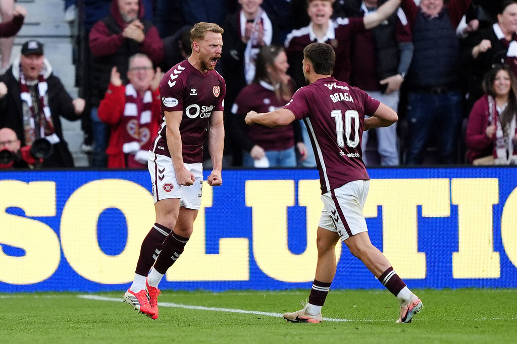 Heart of Midlothian's Stephen Kingsley, left, celebrates scoring a goal with Claudio Braga during the William Hill Premiership soccer match at Tynecastle Park, Edinburgh, Monday, May 4, 2026. (Andrew Milligan/PA via AP)