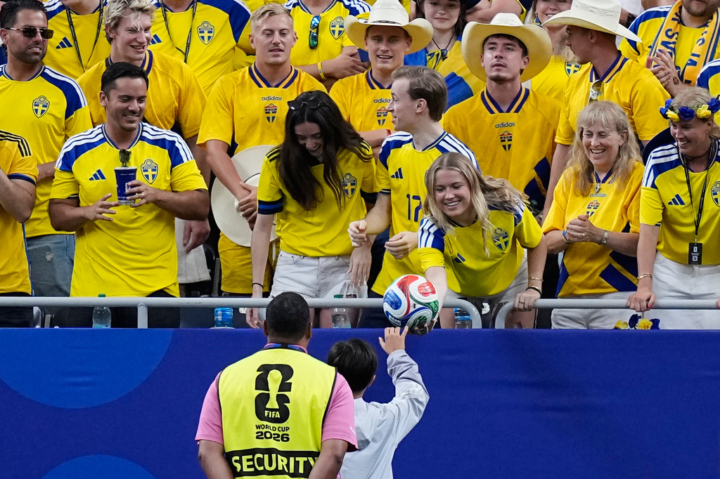 A Sweden fan returns a football that landed on the stands during the World Cup Group F soccer match between the Netherlands and Sweden in Houston, Saturday, June 20, 2026. (AP Photo/Ashley Landis)