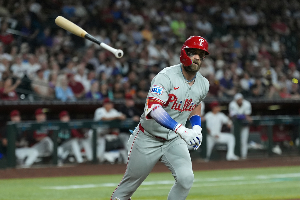 Philadelphia Phillies' Bryce Harper tosses his bat after flying out against the Arizona Diamondbacks during the fifth inning of a baseball game, Monday, Aug. 31, 2026, in Phoenix. (AP Photo/Ross D. Franklin)