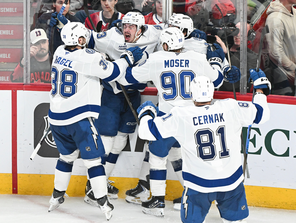 Tampa Bay Lightning's Gage Goncalves, second from left, celebrates with teammates after scoring against the Montreal Canadiens during overtime of Game 6 in the first round of an NHL hockey Stanley Cup playoff series in Montreal, Friday, May 1, 2026. (Graham Hughes/The Canadian Press via AP)