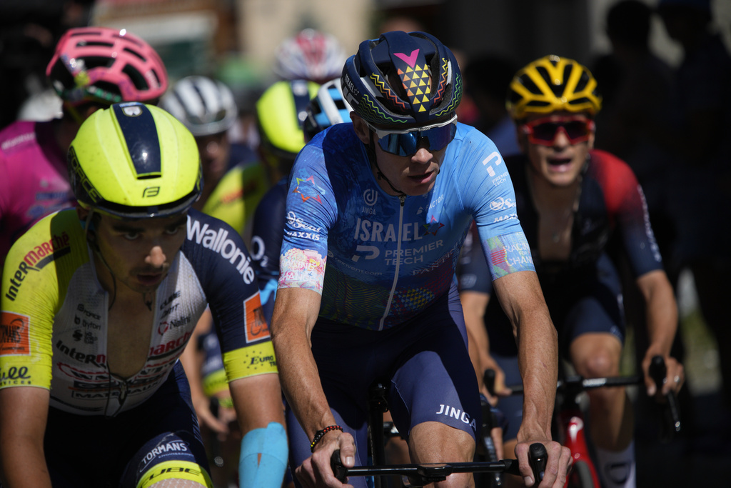 FILE - Belgium's Kobe Goossens, Britain's Chris Froome and Britain's Thomas Pidcock, from left to right, climb Col de la Croix de Fer pass during the twelfth stage of the Tour de France cycling race over 165.5 kilometers (102.8 miles) with start in Briancon and finish in Alpe d'Huez, France, Thursday, July 14, 2022. (AP Photo/Daniel Cole, File)