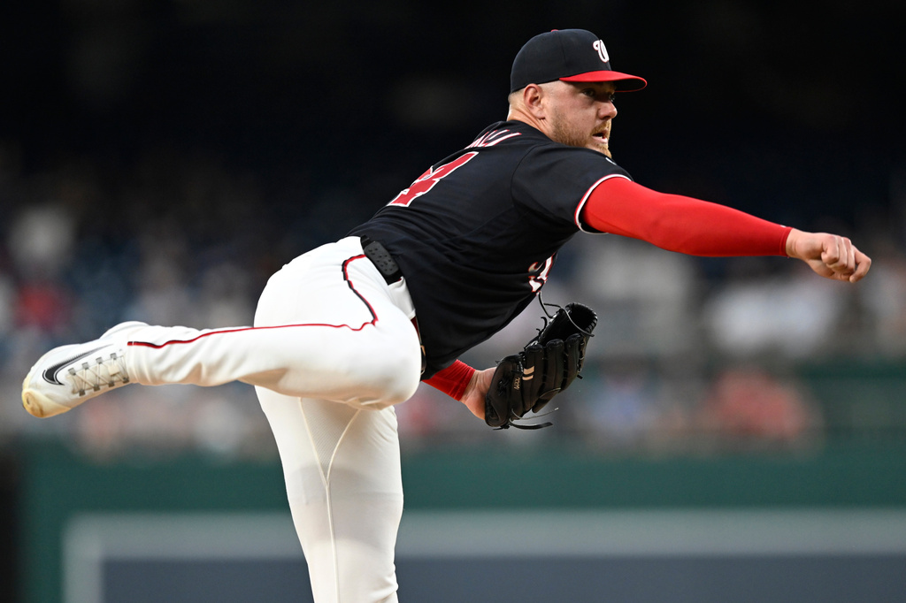 Washington Nationals pitcher Cade Cavalli follows through during the first inning of a baseball game against the Cincinnati Reds, Friday, Aug. 7, 2026, in Washington. (AP Photo/John McDonnell)