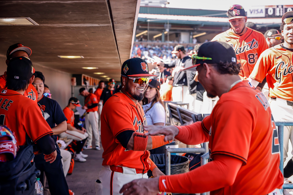 Luis Arraez (1) and Willy Adames (2) hype each other up before their spring training game between the San Francisco Giants and the Chicago Cubs in Scottsdale, Ariz., on Sunday, Feb. 22, 2026. (Carlos Avila Gonzalez/San Francisco Chronicle via AP)