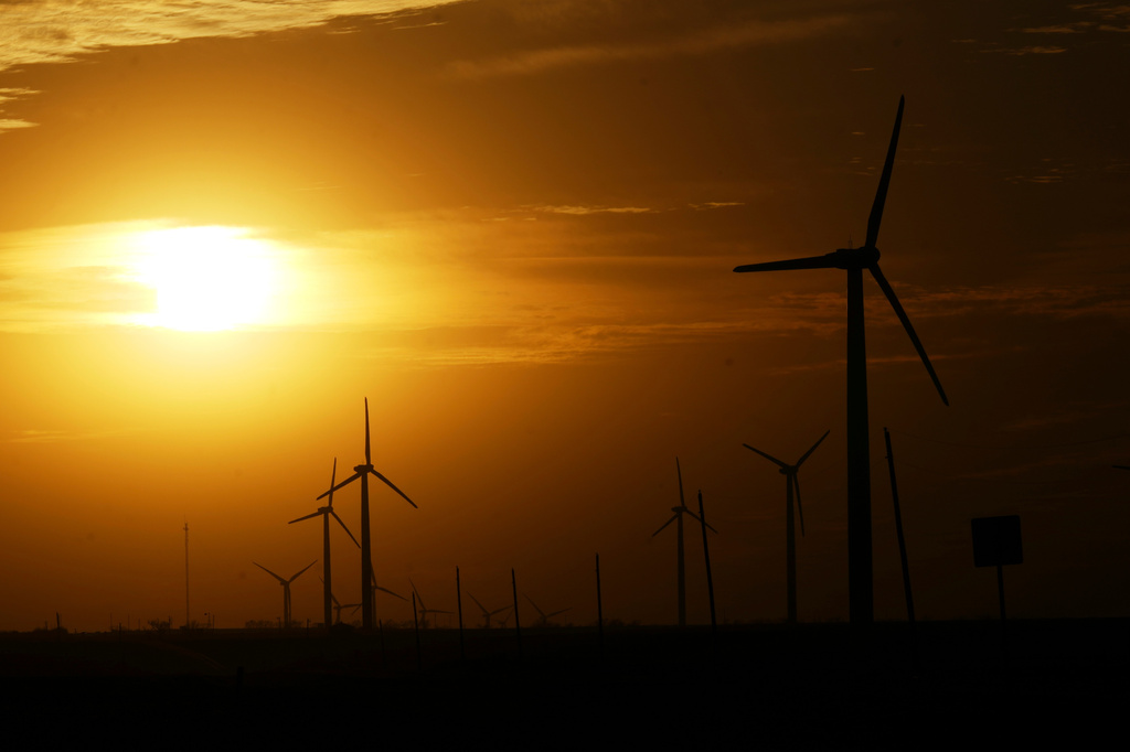 FILE - Wind turbines are visible as the sun begins to set Feb. 26, 2025, in Roscoe, Texas. (AP Photo/Julio Cortez, File)