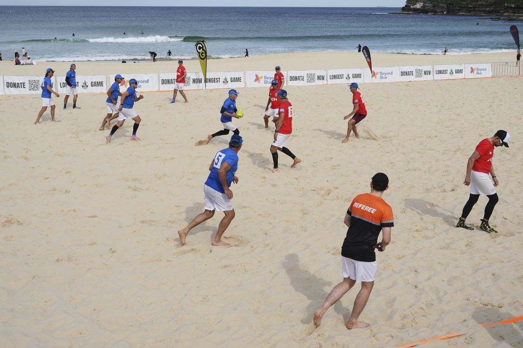 A player runs the ball up during a world record attempt for a game of beach touch rugby on Bondi Beach in Sydney, Australia, Thursday, Sept. 4, 2025. (AP Photo/Mark Baker)