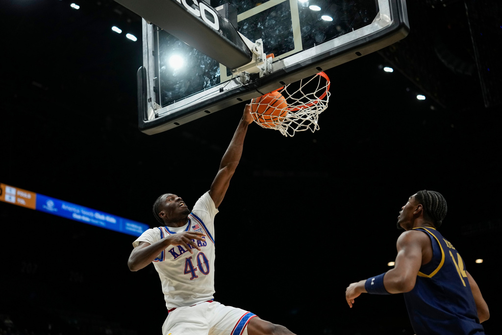 Kansas forward Flory Bidunga (40) dunks the ball against Notre Dame forward Kebba Njie during the first half of an NCAA college basketball game, Monday, Nov. 24, 2025, in Las Vegas. (AP Photo/Lucas Peltier)
