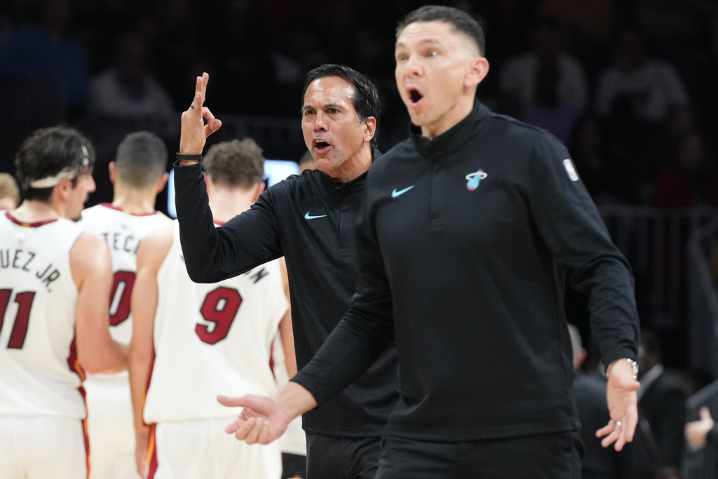 Miami Heat head coach Erik Spoelstra, center and assistant head coach Chris Quinn react to a call during the first half of an NBA basketball game against the Atlanta Hawks Tuesday, Feb. 3, 2026, in Miami. (AP Photo/Marta Lavandier)
