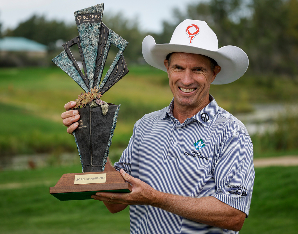 New Zealand's Stephen Alker lifts the trophy after winning the PGA Tour Champions golf event in Calgary, Alberta, Sunday, Aug. 23, 2026. (Jeff McIntosh/The Canadian Press via AP)