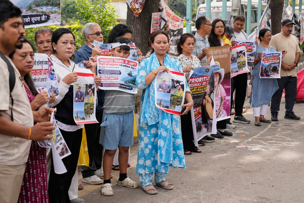 Relatives of recent flash flood victims hold banners urging authorities to step up efforts to find their missing loved ones during a demonstration in Kathmandu, Nepal, Monday, Sept. 7, 2026. (AP Photo/Dar Yasin)