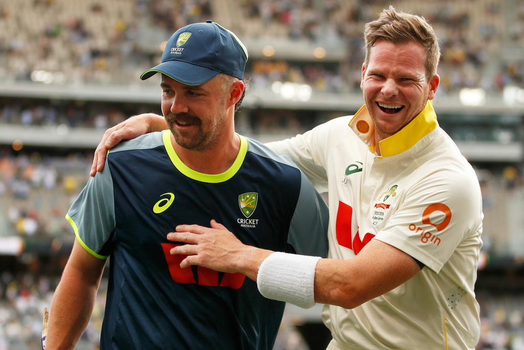 Australia's captain Steve Smith, right, and Travis Head celebrate after winning their first Ashes cricket test match against England in Perth, Saturday, Nov. 22, 2025.(AP Photo/Gary Day)