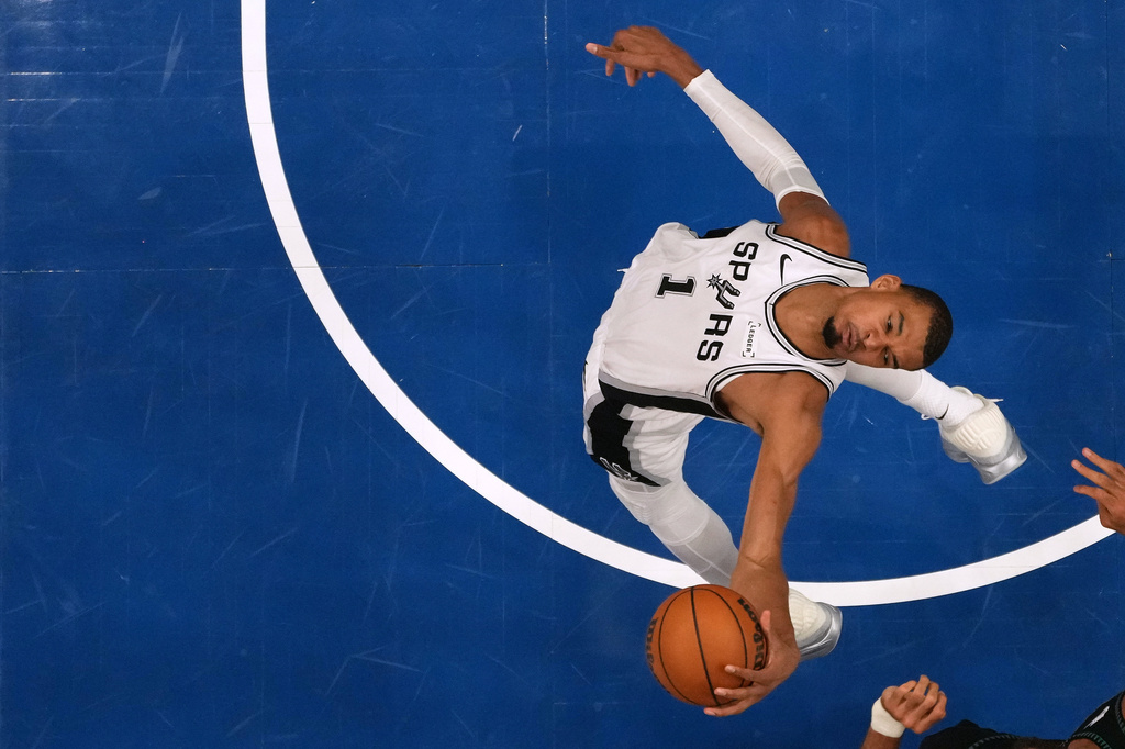San Antonio Spurs forward Victor Wembanyama (1) grabs a rebound during the second half of Game 3 of a NBA basketball second-round playoff series against the Minnesota Timberwolves, Friday, May 8, 2026, in Minneapolis. (AP Photo/Abbie Parr)
