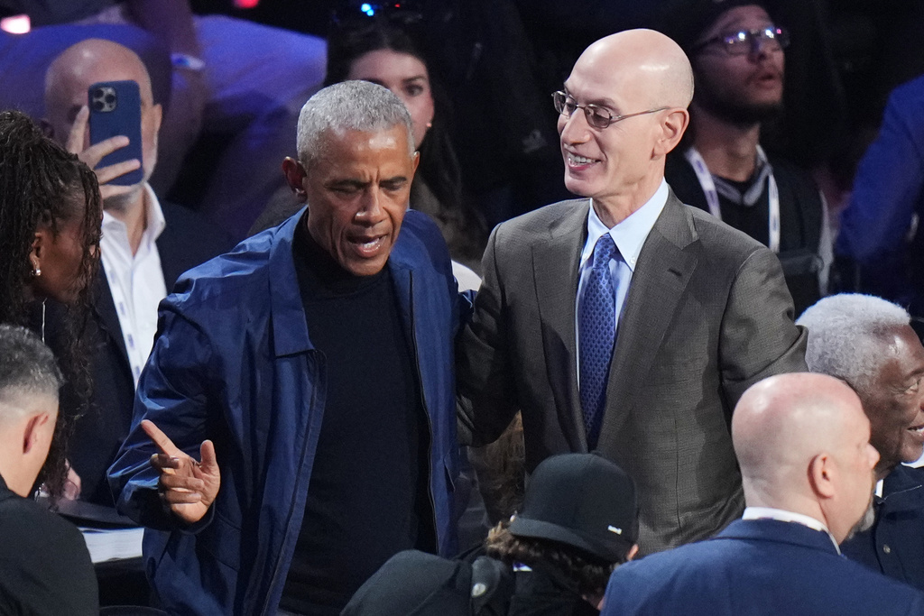 Barack Obama talks to commissioner Adam Silver before the NBA All-Star basketball game Sunday, Feb. 15, 2026, in Inglewood, Calif. (AP Photo/Jae C. Hong)