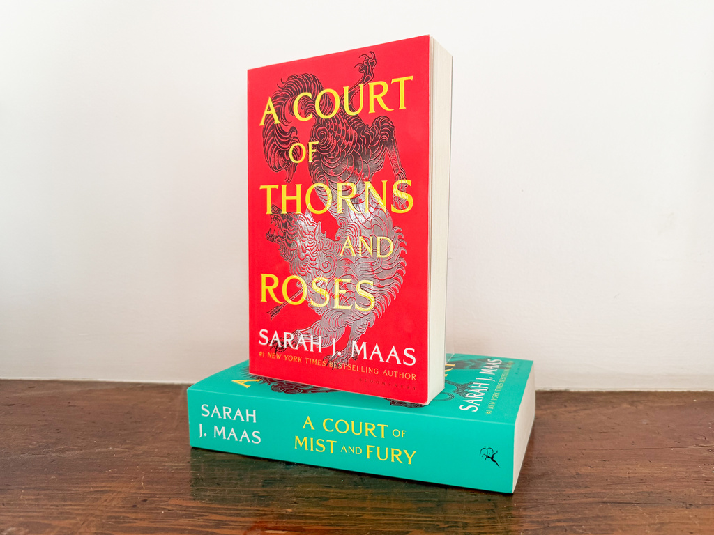 "A Court of Thorns and Roses," top, and "A Court of Mist and Fury," the first two books in author Sarah J. Maas' A Court of Thorns and Roses series are shown on a shelf in Los Angeles on Friday, March 6, 2025. (AP Photo/Anthony McCartney