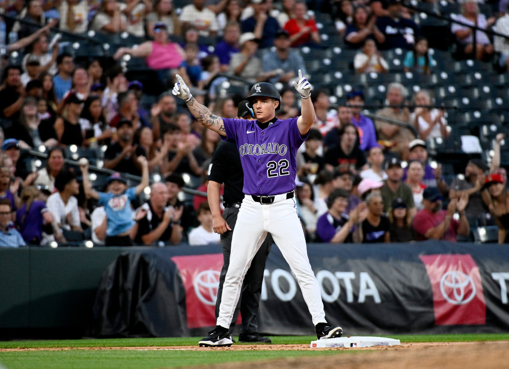 Colorado Rockies' Mickey Moniak celebrates on third base after hitting a two-run triple in the fifth inning of a baseball game against the Miami Marlins Wednesday, July 1, 2026, in Denver. (AP Photo/Geneva Heffernan)