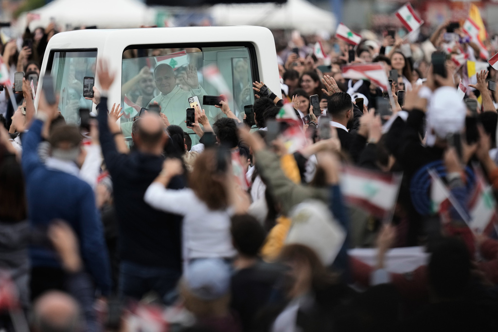 FILE - Pope Leo XIV waves to the crowd as he arrives to celebrate a Holy Mass at Beirut waterfront, in Beirut, Lebanon, Tuesday, Dec. 2, 2025. (AP Photo/Bilal Hussein, File)